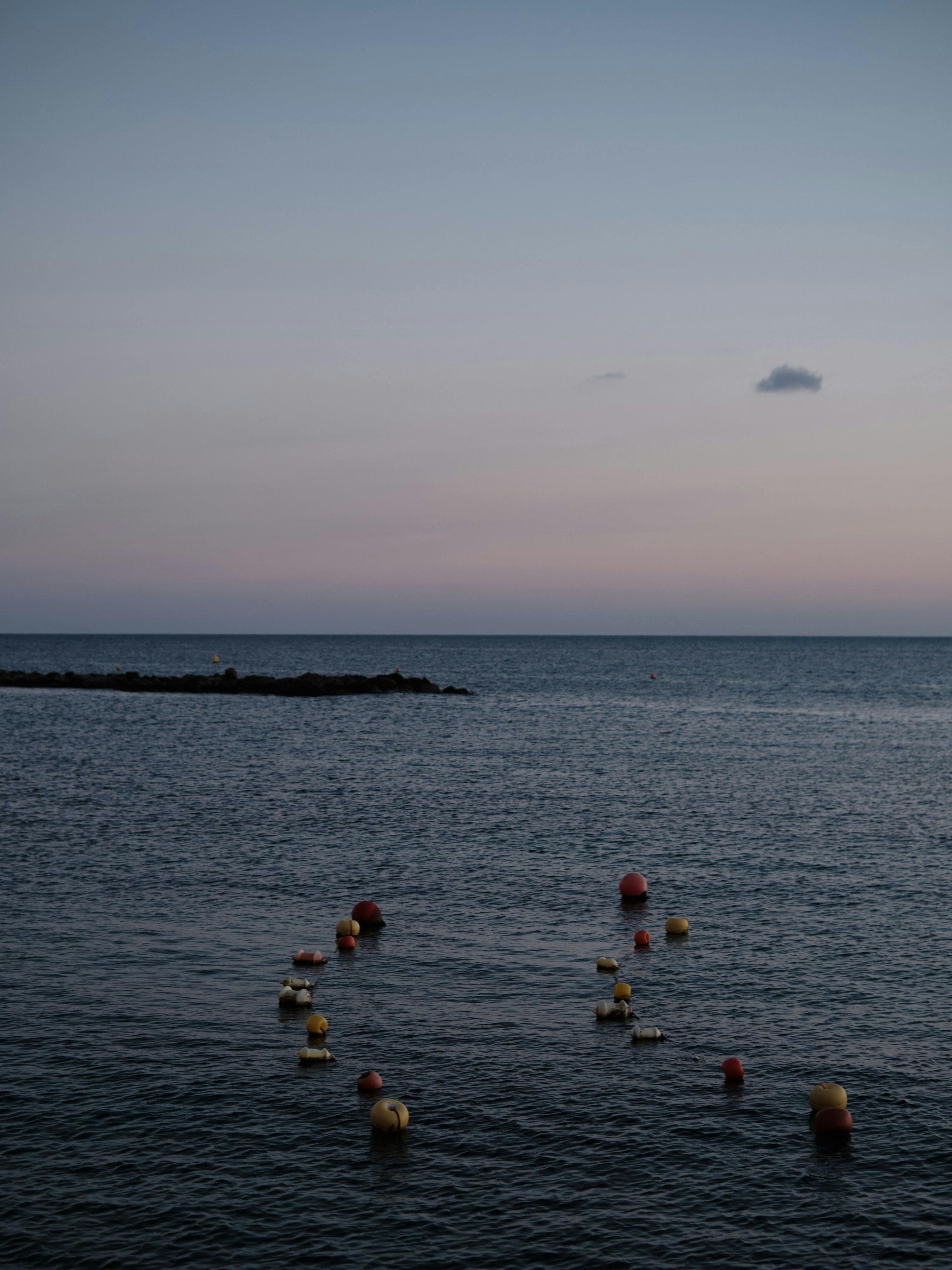 A series of buoys to guide small boats out to sea at dusk